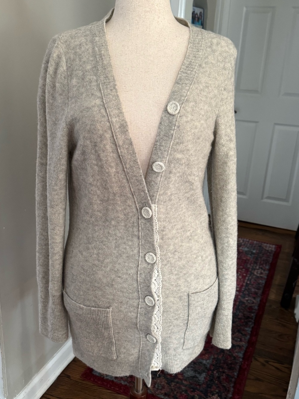 Women’s wool alpaca blend cardigan sweater with lace details.